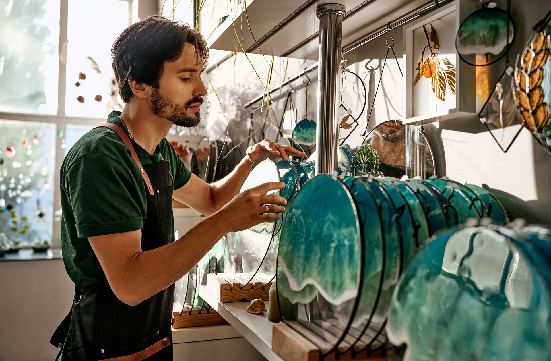 Small business owner of a home decor store. The seller takes the decor from the store shelf.